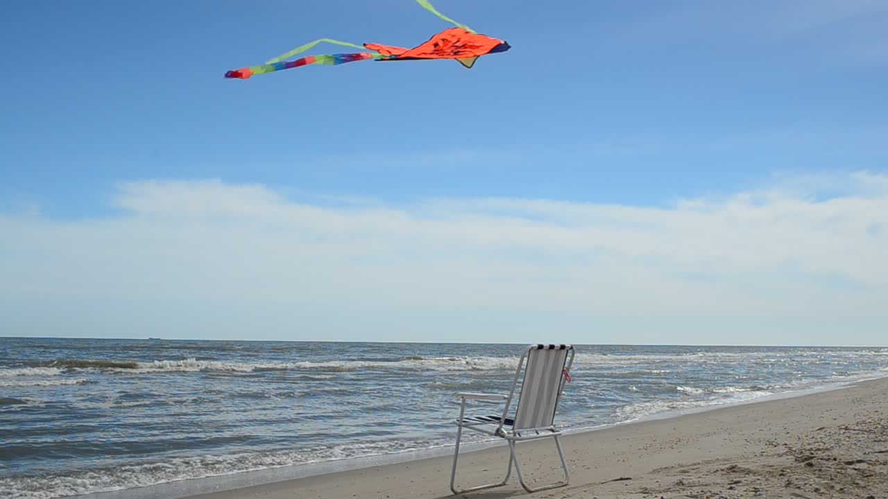 Chaise lounge on the beach, the sea and a kite. Summer Time in Beach Sea Shore