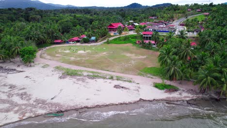 people on beach near coastal village