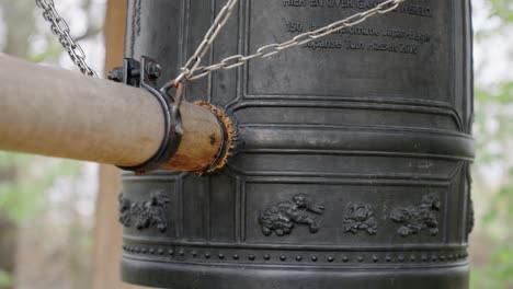 wooden round pile hits the peace bell in the largest japanese garden of europe in hasselt, belgium