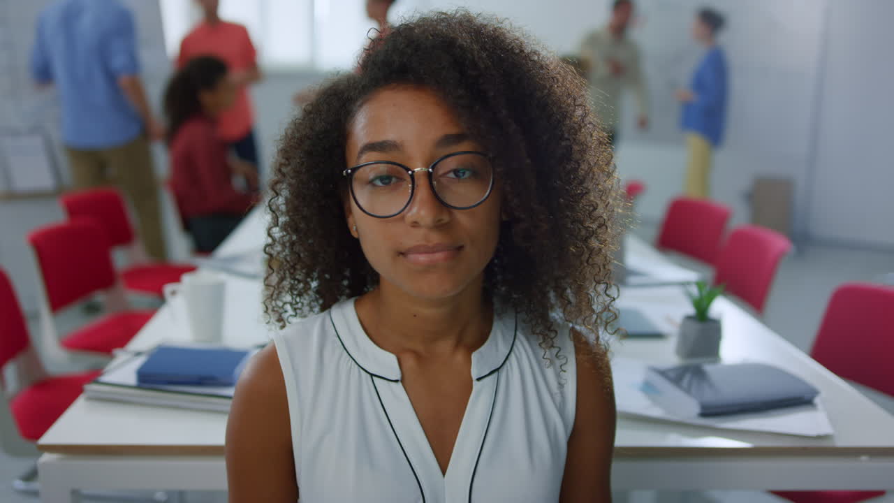 African businesswoman looking camera office. Serious woman standing meeting room