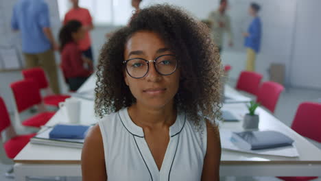 african businesswoman looking camera office. serious woman standing meeting room