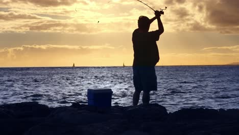 silhouette of a fisherman at sunset