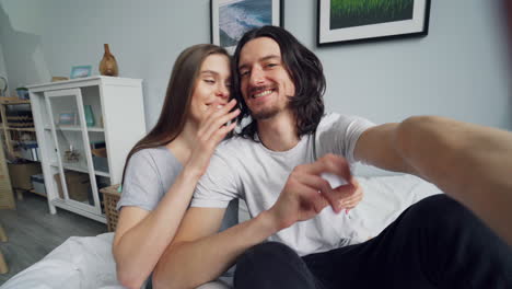 couple taking selfie in bedroom