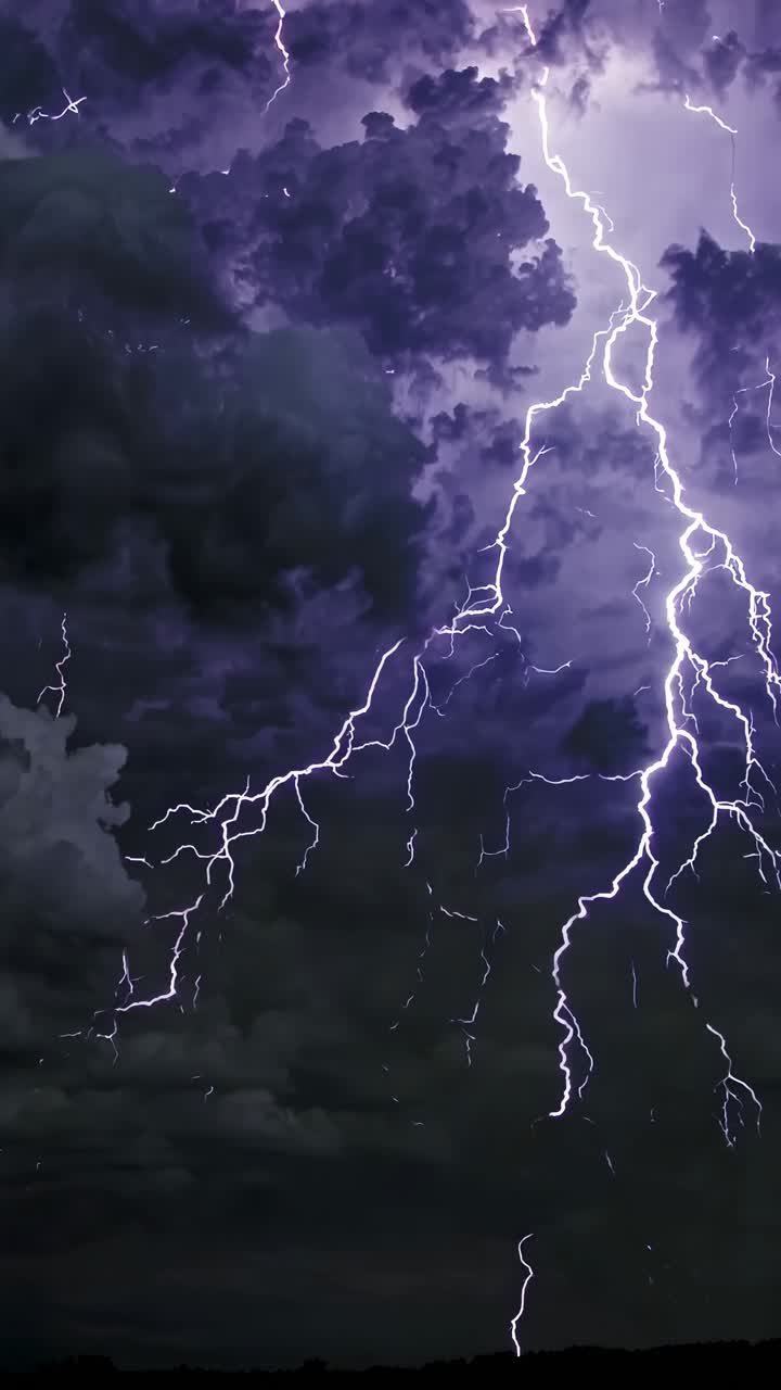 Dramatic video of towering storm clouds with lightning, captured from a low angle