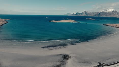 turquoise waters of yttersand beach near roren-ytresandheia mountain hike in lofoten islands, norway. aerial drone shot