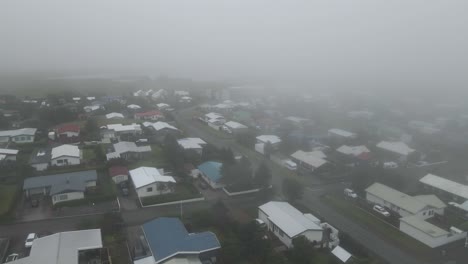 Hover over H&ouml;fn&#039;s quaint neighborhood shrouded in fog with our drone&#039;s eye view, revealing the town&#039;s serene atmosphere in high-definition 4K