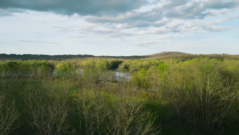 Lake-sequoyah,-ar,-lush-trees-under-a-vast-sky-at-dusk,-serene-landscape,-aerial-view