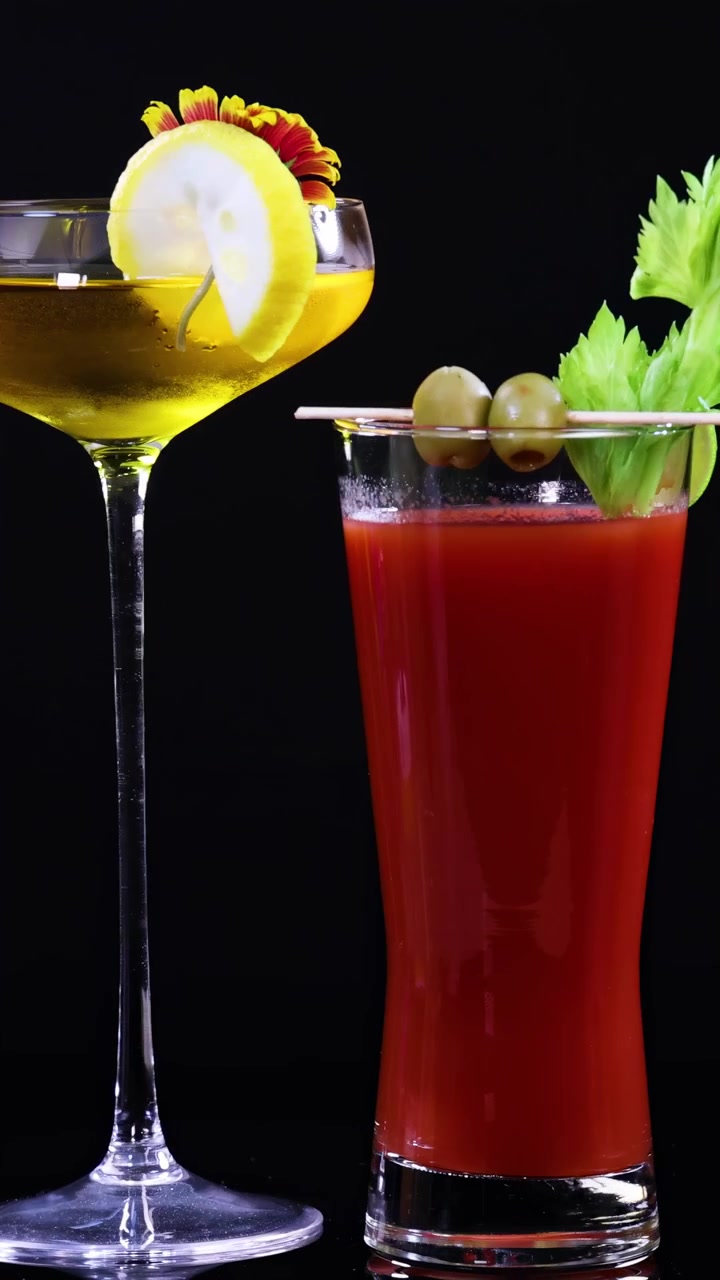 Two vibrant cocktails with garnishes in a dark setting, highlighting vivid colors and elegant presentation