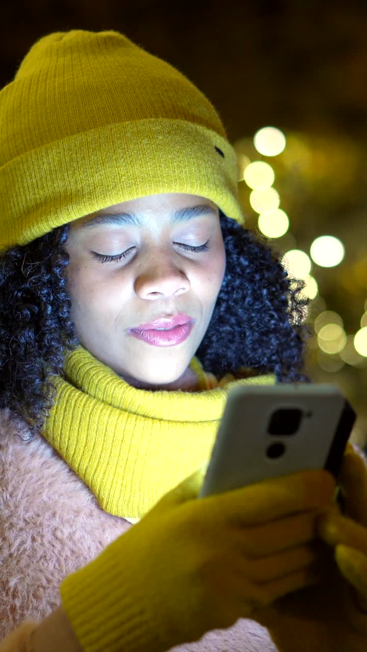 Woman using smartphone in winter