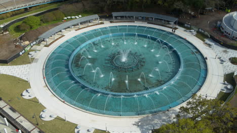 Static-aerial-footage-of-the-friendship-fountain-in-Jacksonville,-Florida-with-people-walking-around-it-during-the-day