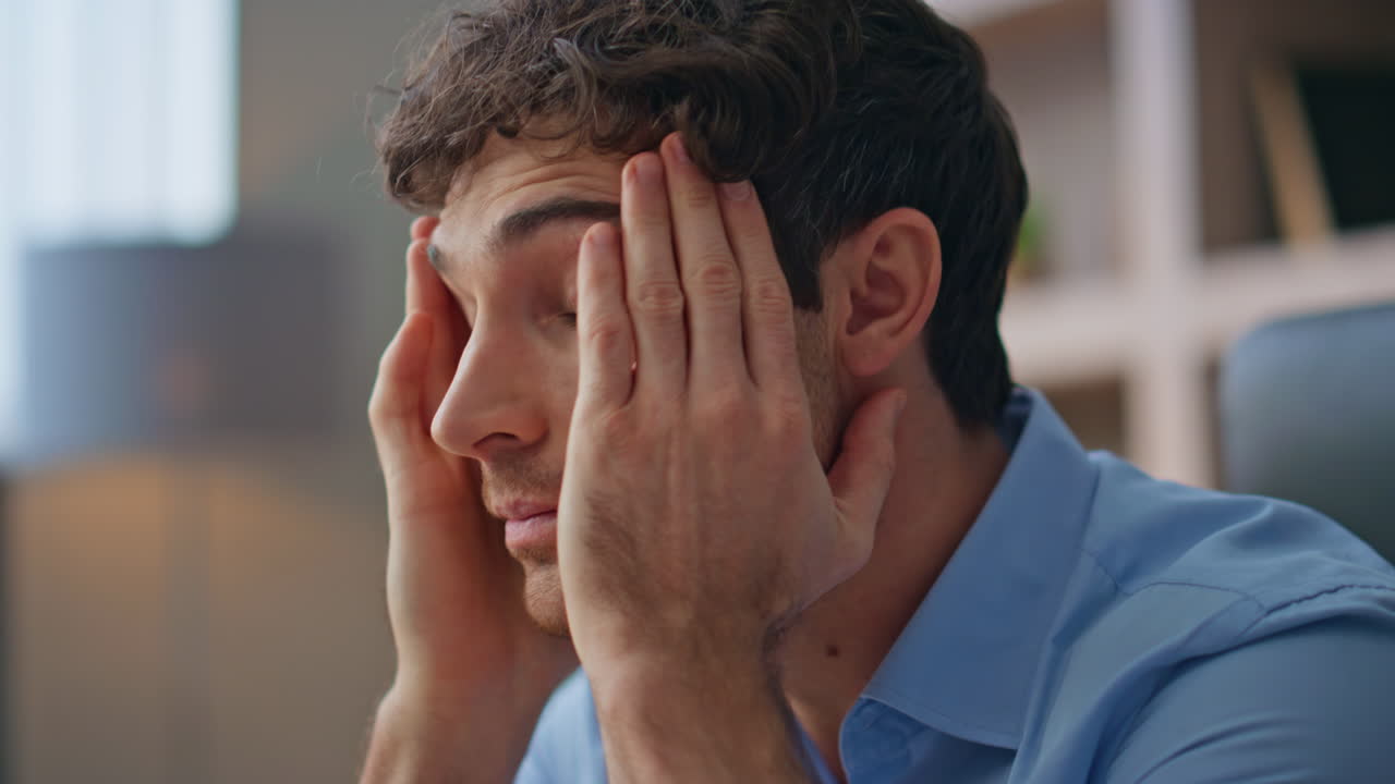 Exhausted manager reading documents in office closeup. Tired man suffer headache
