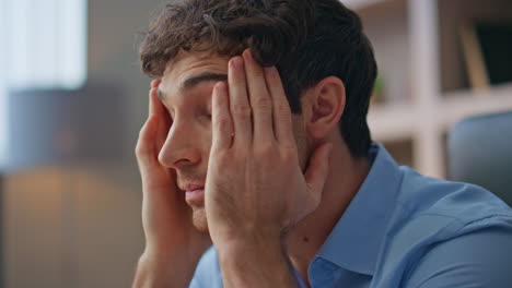 exhausted manager reading documents in office closeup. tired man suffer headache