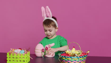 joyful young kid playing around with festive painted decorations