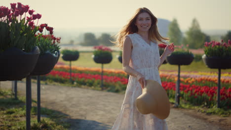 Pretty-girl-jumping-with-lightness-and-elegance-in-spring-flower-garden-outside.