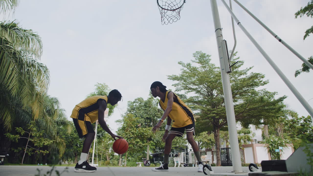 Sportsman Practicing Ball Steal Playing Streetball with Friend