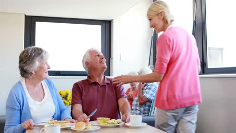 Senior-couple-interacting-with-eachother-while-having-breakfast