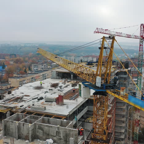 view from above on construction site with crane. big construction crane on a building background. aerial view. slow motion.
