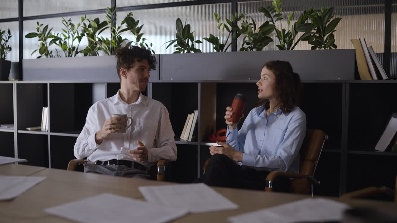 Business Colleagues Having Coffee and Discussion in Office