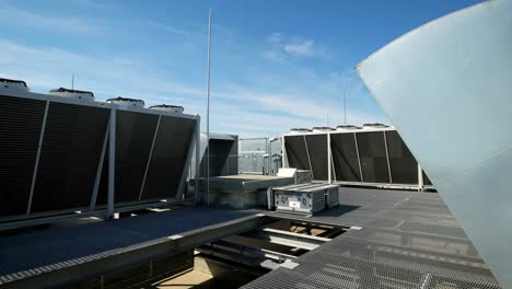 large ventilation system installed on the roof of an industrial building. purification of indoor air with the help of external equipment. beautiful blue sky on the background