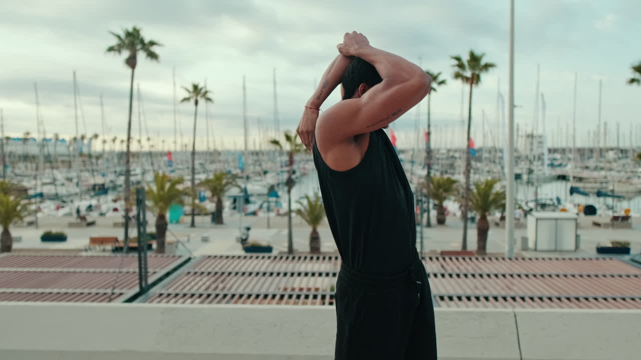 Young Man Stretching By The Marina
