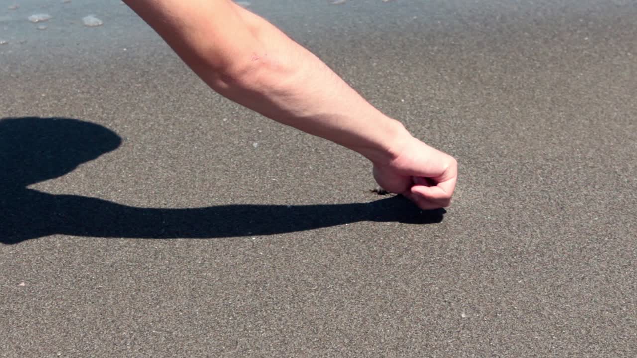 Young Man Writte Heart On Sand Beach