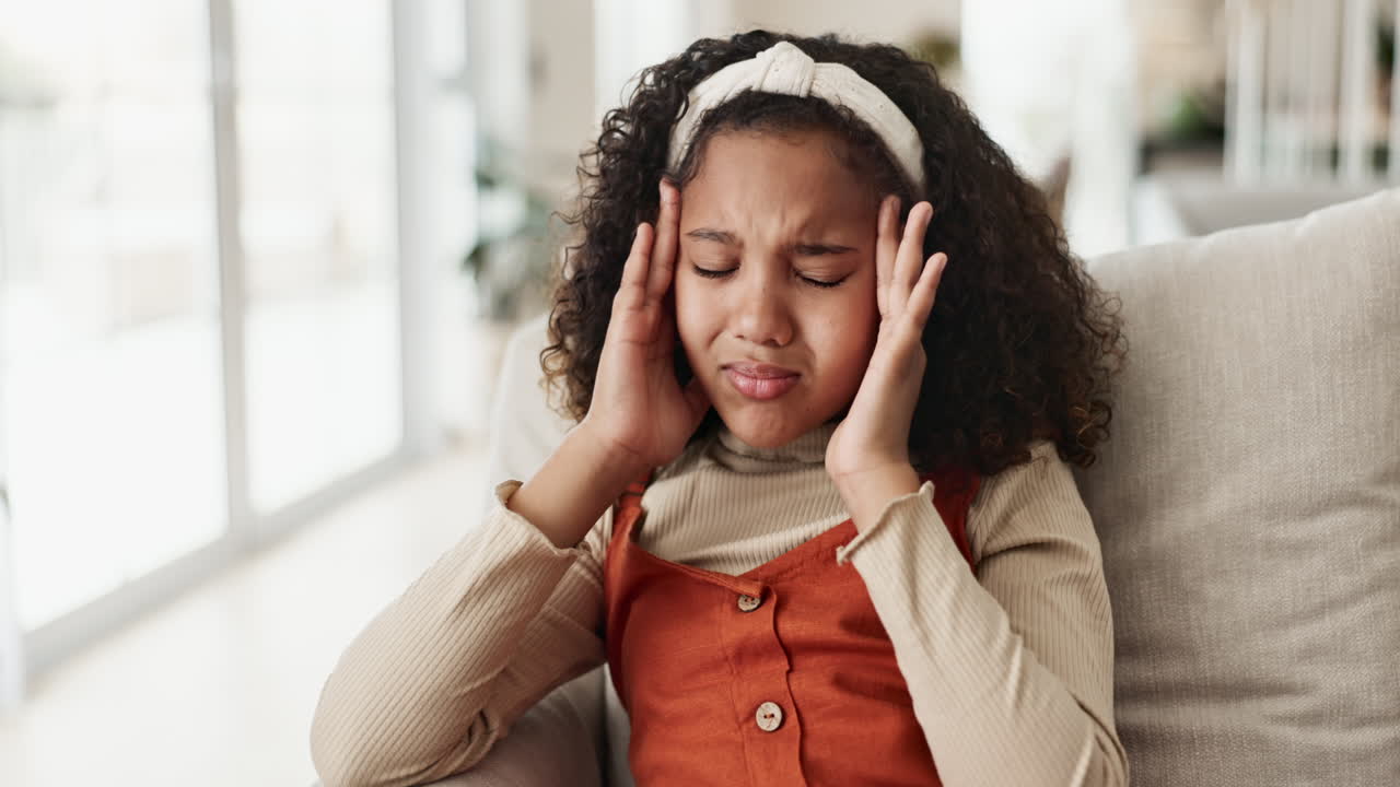 A young girl experiencing a headache