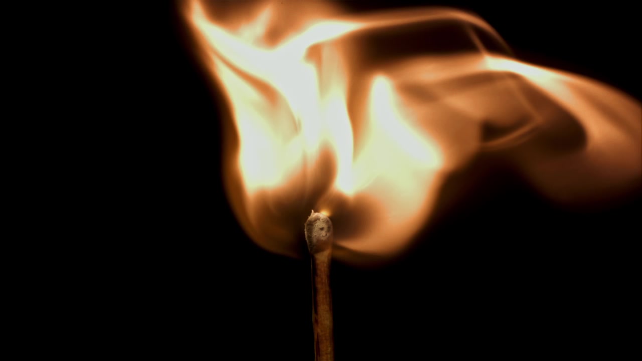 Slow Motion Close-Up of a Match Igniting and Burning