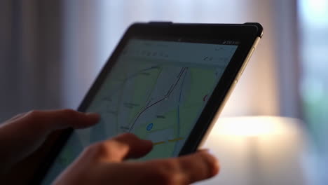 person using a tablet to navigate a map application