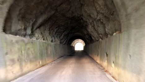 driving on the road, under the mountain tunnel