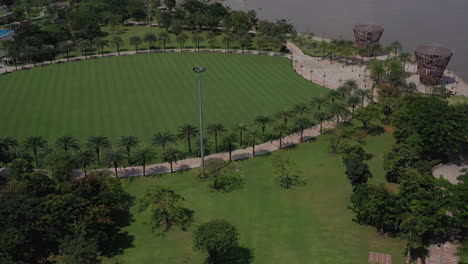 aerial view of a beautifully landscaped park on a clear sunny day with colorful children's playground tennis courts and putting green