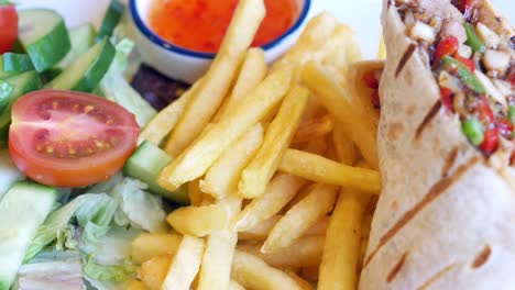 delicious wrap with fries and salad