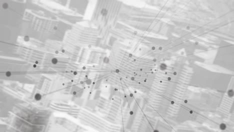 Animation-of-dots-and-connections-over-grey-cityscape