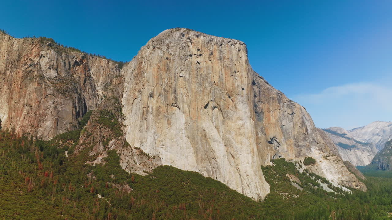 Vertical mountain formation in Yosemite National Park. The EL Capitan Rock in the rays of bright sun. Low angle view.