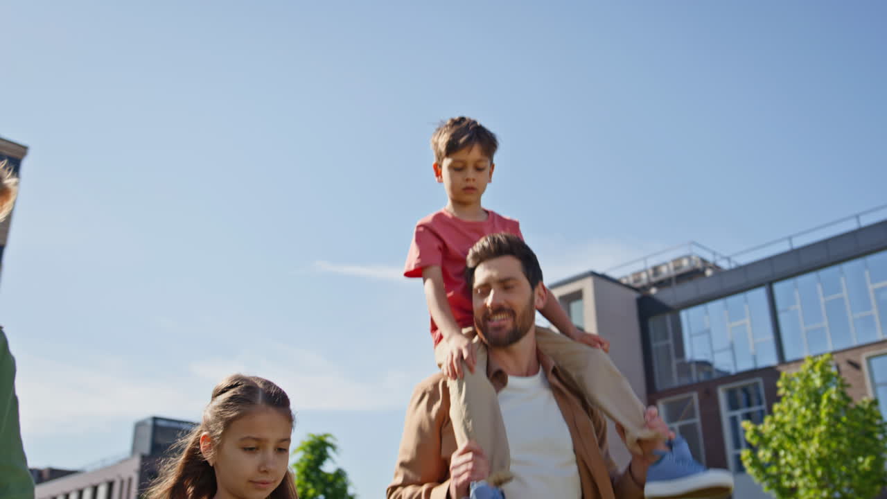 Happy generations walking sunshine park enjoying holiday. Boy pointing finger