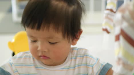 a sweet moment showcasing a baby girl receiving loving care in a serene home setting.