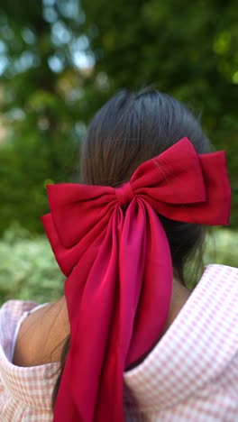 woman with a red bow in her hair