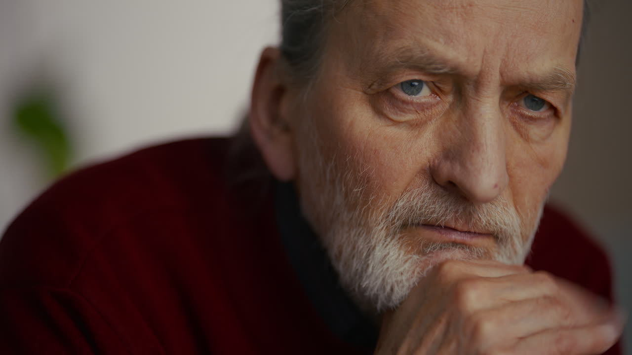 Close Up of Thoughtful Elderly Man with Beard Closing Eyes