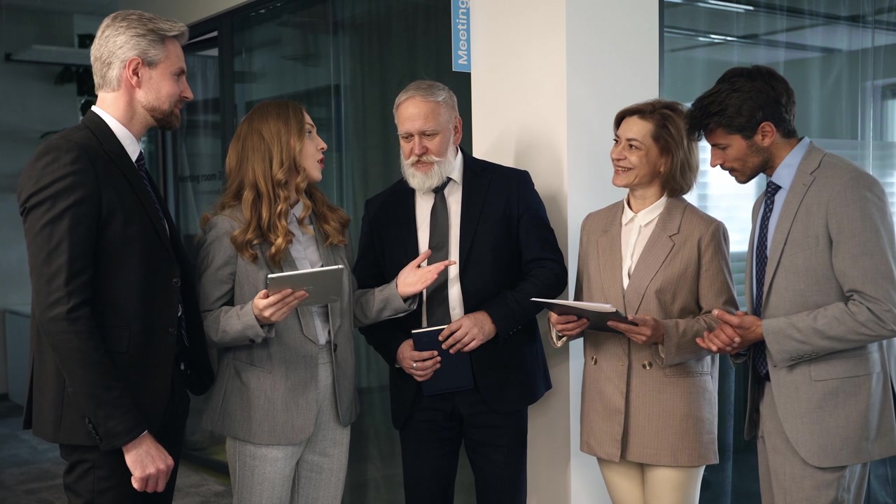 Diverse Business Team Discussing Project on Tablet in Modern Office