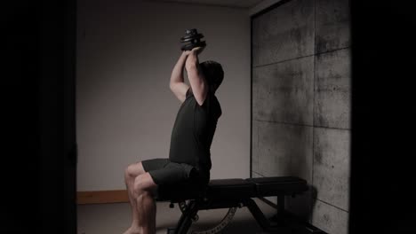 Seated-dumbbell-tricep-extension,-cinematic-lighting,-white-man-dressed-in-black-gym-attire