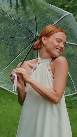 woman with umbrella in a park on a rainy day