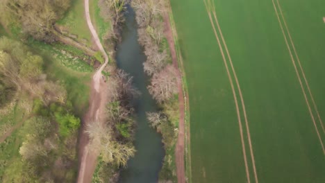 4k flying over the river tone near french weir park in taunton somerset, drone flying backwards