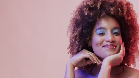 Biracial-woman-with-dark-hair-in-blue-and-pink-light-with-copy-space,-slow-motion