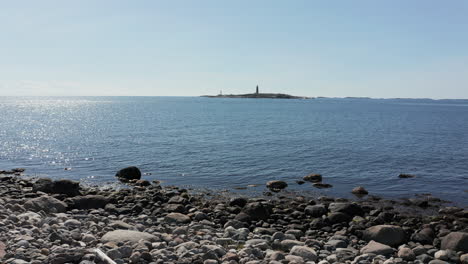 Dolly-in-Toward-Lille-Torungen-Lighthouse-from-Nearby-Island-Across-Sea,-Norway