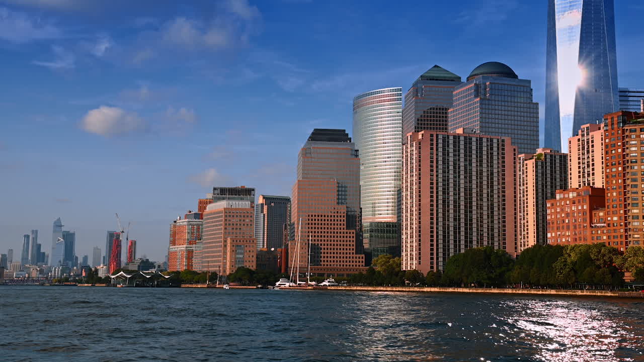 Spectacular modern high-rise buildings at the waterfront of New York, USA. Travelling by the river by boat for sightseeing in metropolis