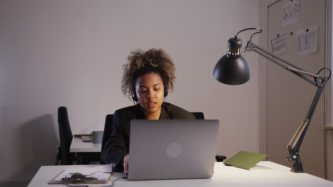 Woman working from home at night