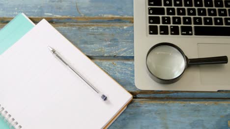 organizer, pen, magnifying glass and laptop on table 4k