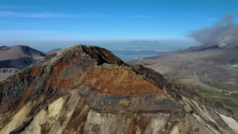 wide rotating drone shot of mountain range near the volcano mount aso