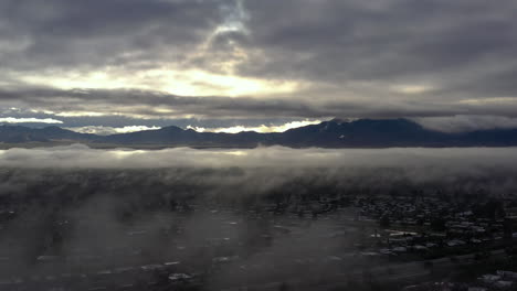 slow moving drone shot of thick fog over green valley, arizona usa