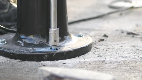 installing a black metal base on concrete