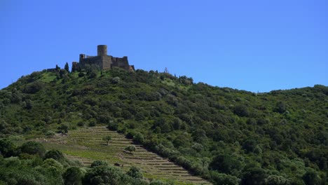 Fort-Saint-Elme-sitting-proudly-on-top-of-the-hill-on-a-windy-day-above-the-historic-town-of-Collioure-in-the-south-of-France